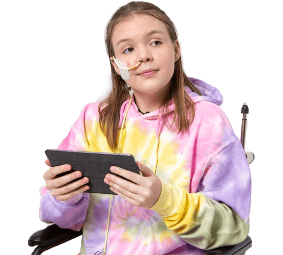A female young adult wearing rainbow tie dye sweatshirt, looking afar from her wheelchair, holding an iPad device in her hand.